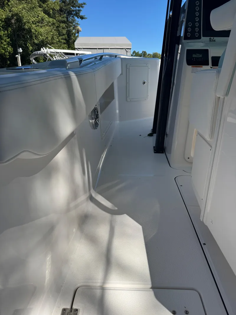 Slide: The Image of 2024 Robalo R302 Center Console boat interior, featuring sleek white deck and modern design. - 14