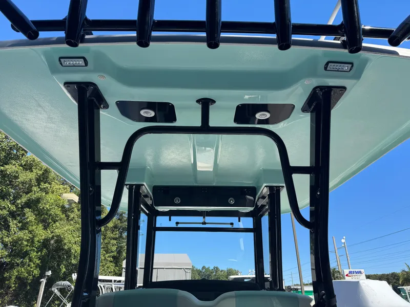 Slide: The Image of 2024 Robalo R302 Center Console boat roof and structure, featuring sturdy design and modern fixtures. - 15