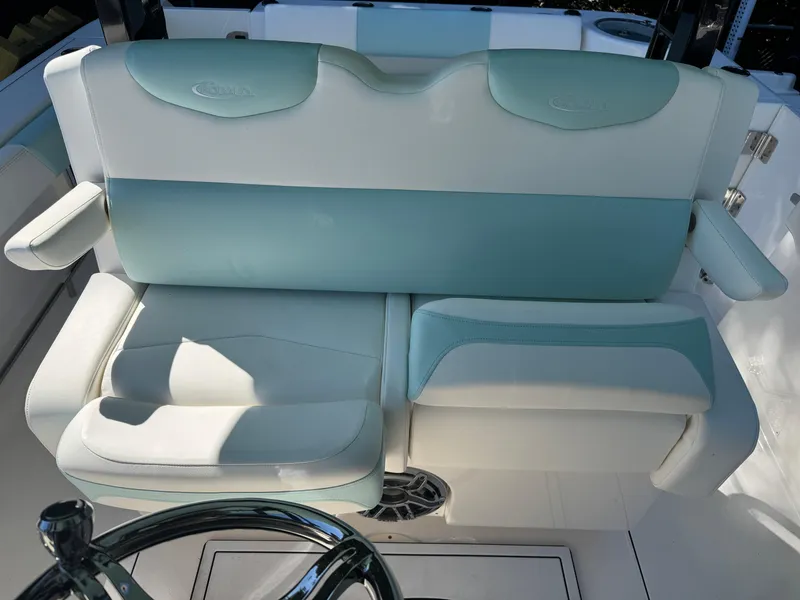 Slide: The Image of 2024 Robalo R302 Center Console boat seating, featuring stylish blue and white upholstery. - 17