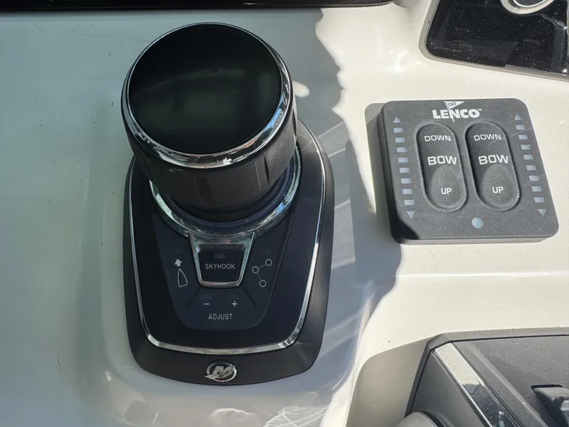 Slide: The Image of 2024 Robalo R302 Center Console boat controls, featuring joystick and Lenco trim tab buttons. - 21