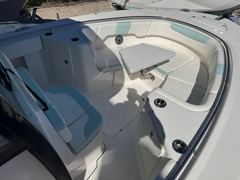 Slide: The Image of 2024 Robalo R302 Center Console boat interior with seating and table. - 28
