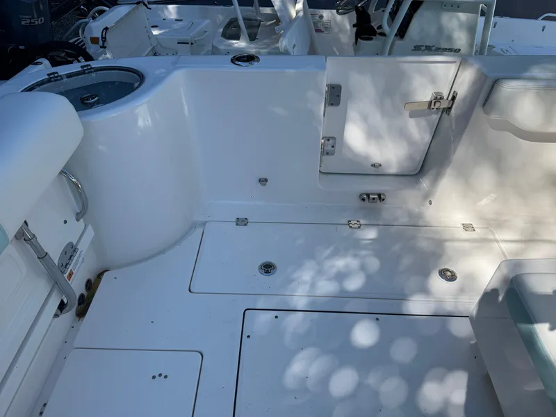 Slide: The Image of 2024 Robalo R302 Center Console boat deck with storage compartments and seating. - 8