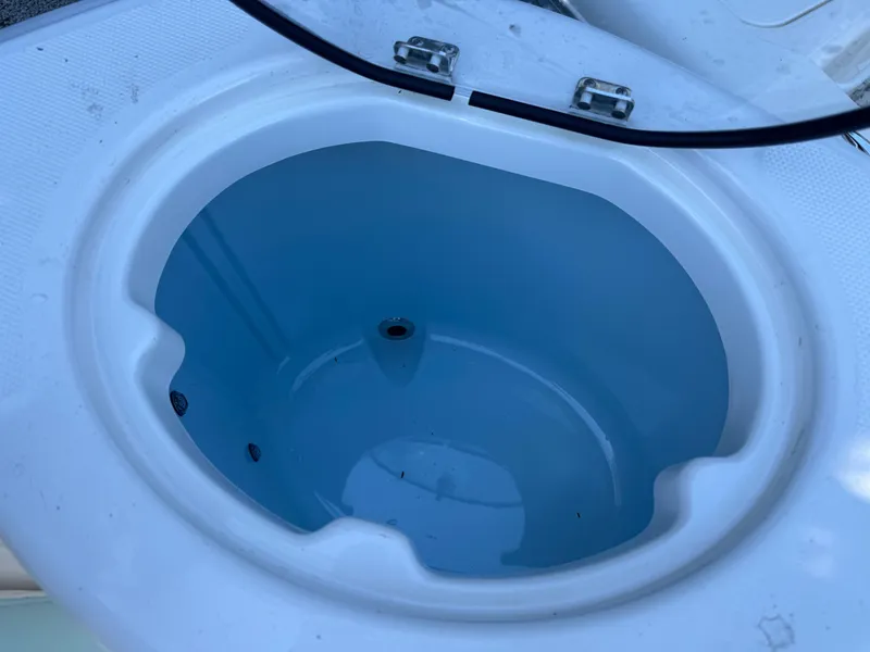 Slide: The Image of 2024 Robalo R302 Center Console livewell with open lid. - 9