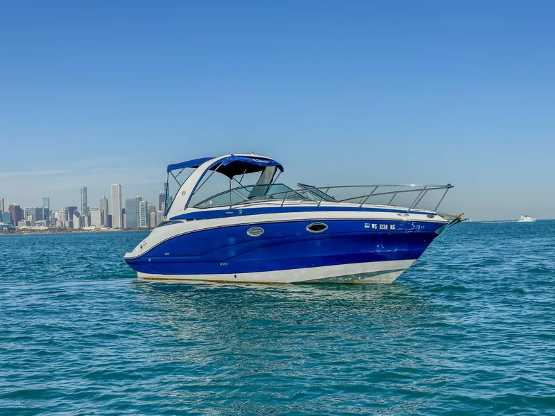Slide: The Image of 2020 Crownline 264 CR boat on water with city skyline in background. - 0