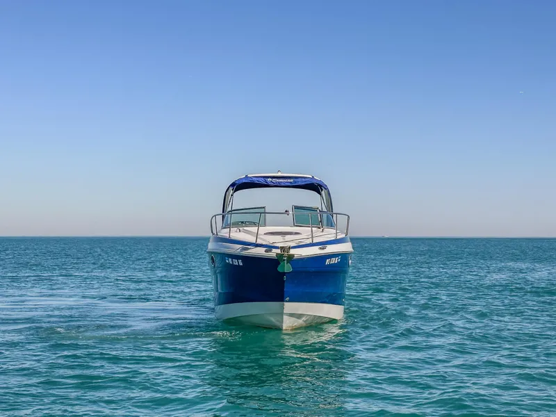 Slide: The Image of 2020 Crownline 264 CR boat on open water under clear blue sky. - 1