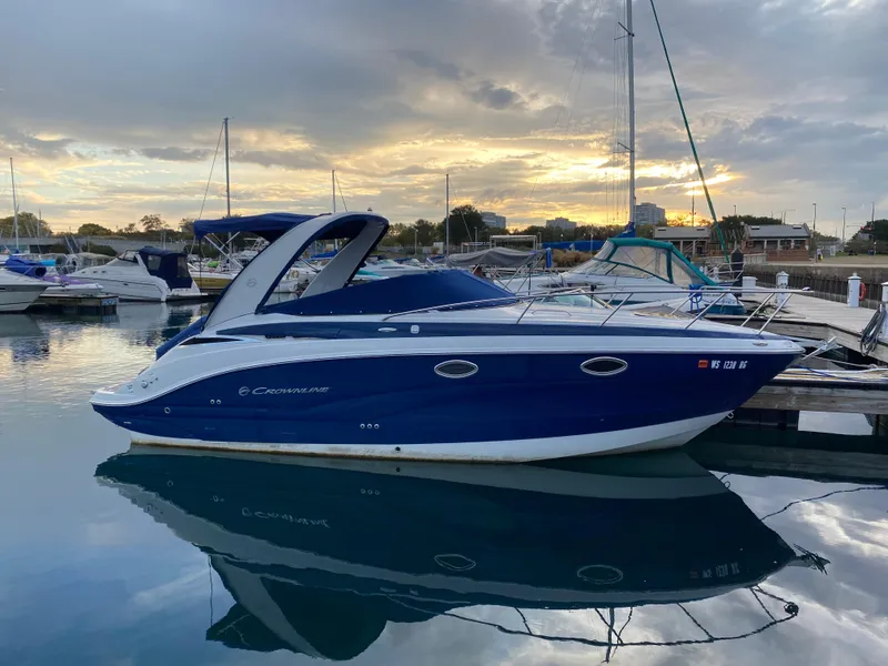 Slide: The Image of 2020 Crownline 264 CR boat docked at marina during sunset. - 13