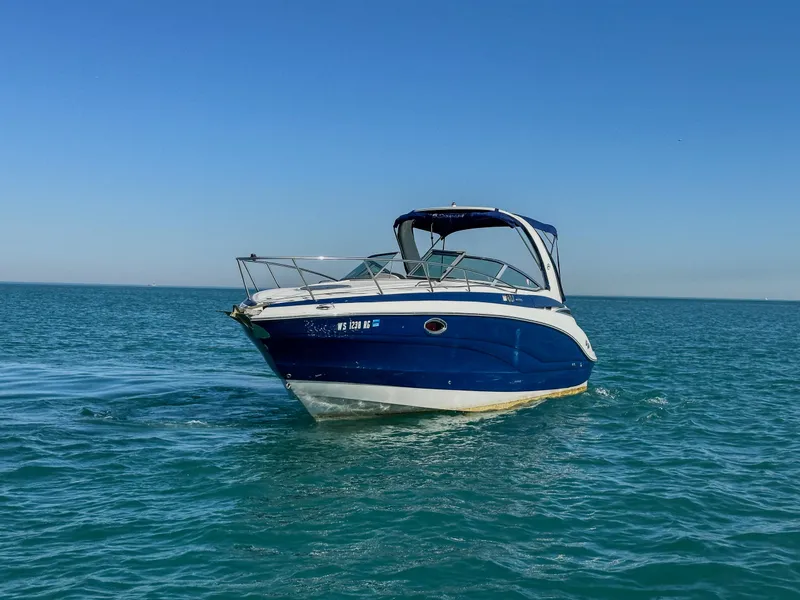 Slide: The Image of 2020 Crownline 264 CR boat on open water under clear blue sky. - 3