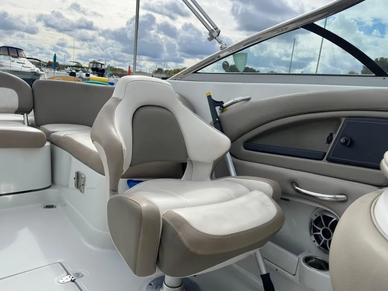 Slide: The Image of 2020 Crownline E235XS boat interior with plush seating and modern dashboard. - 15