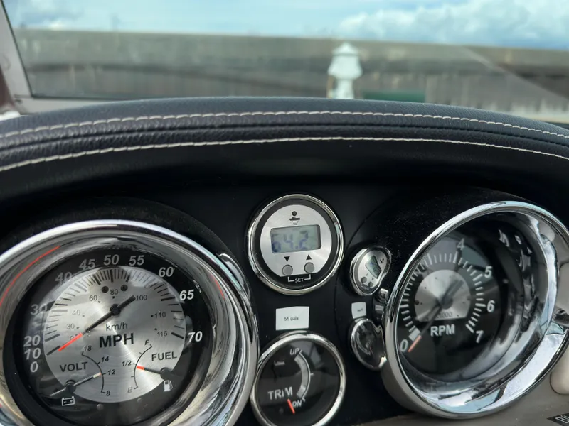 Slide: The Image of Dashboard of 2020 Crownline E235XS boat showing speedometer and RPM gauges. - 20