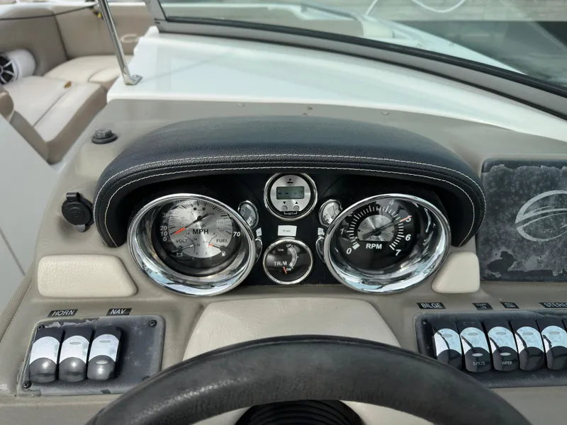 Slide: The Image of Dashboard of 2020 Crownline E235XS boat with gauges and controls. - 21