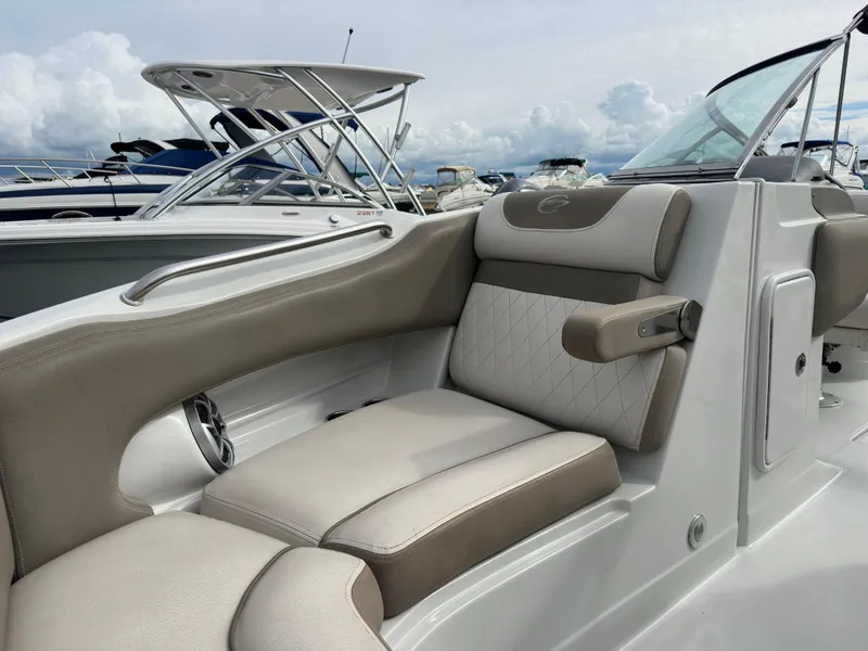 Slide: The Image of 2020 Crownline E235XS boat interior with beige seating and sleek design. - 22