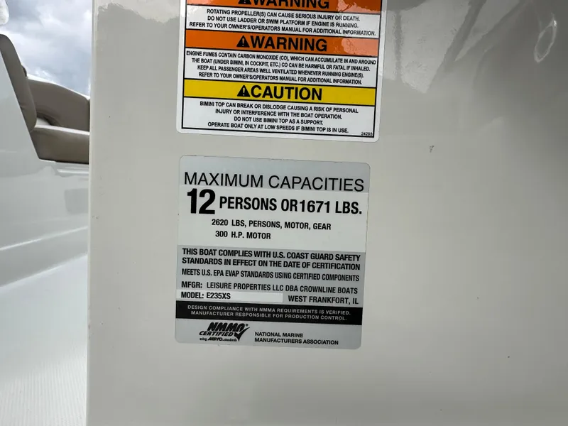 Slide: The Image of 2020 Crownline E235XS capacity label: 12 persons or 1671 lbs, 300 HP motor. - 26