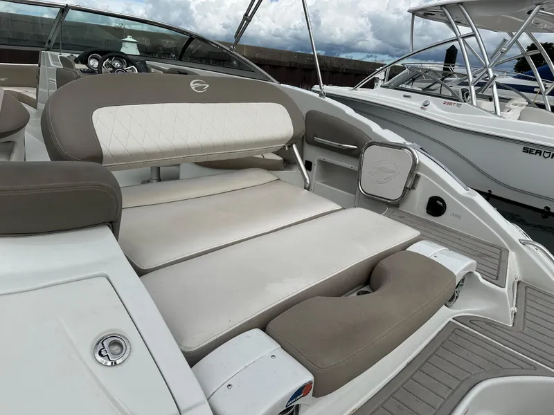 Slide: The Image of 2020 Crownline E235XS boat interior with cushioned seating and modern design. - 6