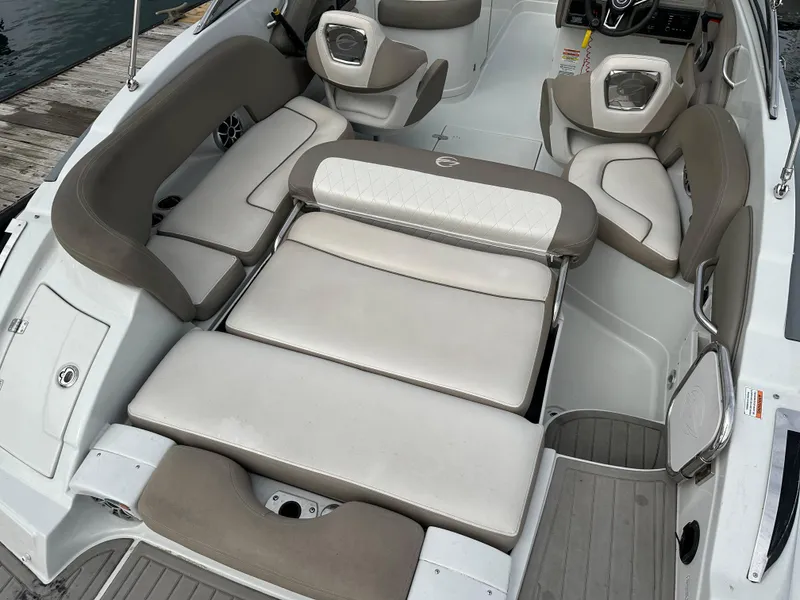 Slide: The Image of 2020 Crownline E235XS boat interior with cushioned seating and modern design. - 7