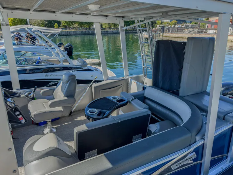 Slide: The Image of 2022 Avalon Catalina FunShip pontoon boat interior with seating and steering console. - 14