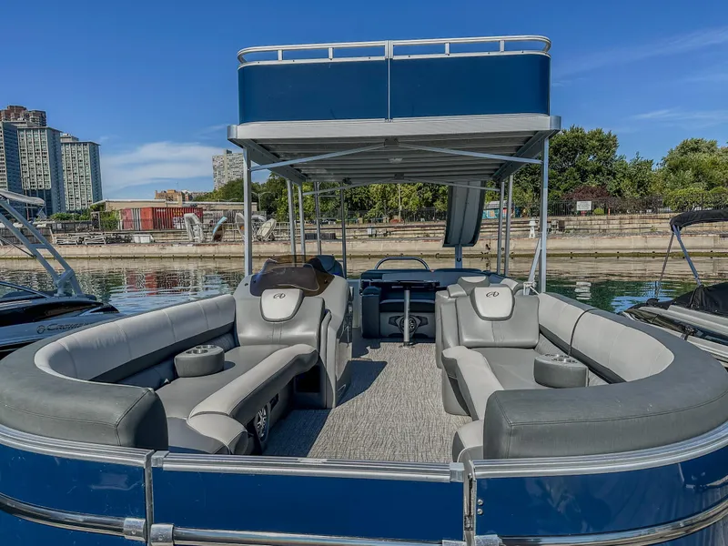 Slide: The Image of 2022 Avalon Catalina FunShip pontoon boat with spacious seating and upper deck, docked by the water. - 4