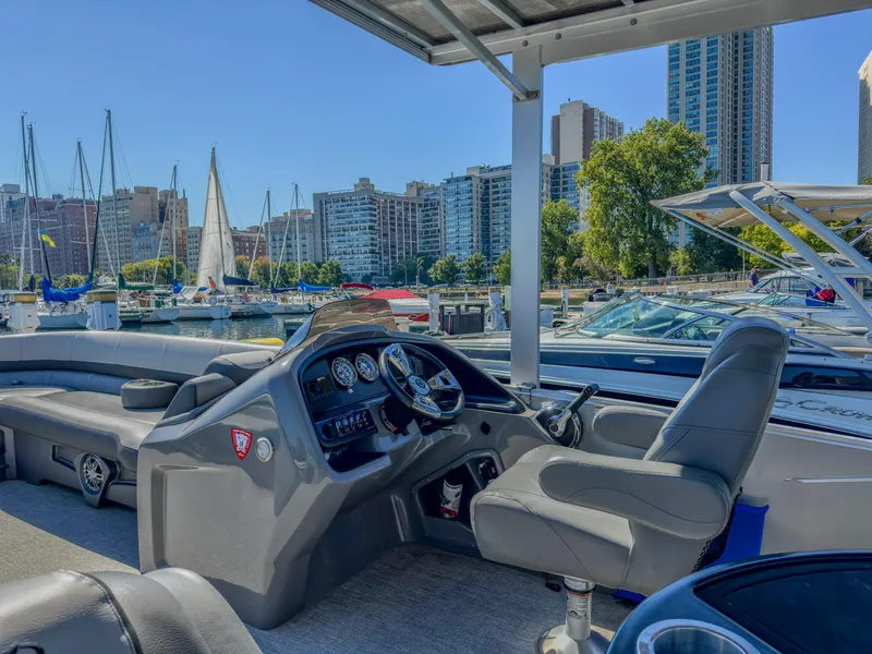 Slide: The Image of 2022 Avalon Catalina FunShip boat interior at marina with city skyline. - 6