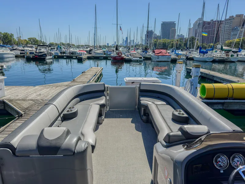 Slide: The Image of 2022 Avalon Catalina FunShip pontoon boat docked in a marina with city skyline. - 7