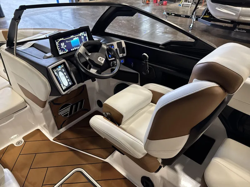 Slide: The Image of 2024 Malibu 23LSV boat interior with modern dashboard and comfortable seating. - 10