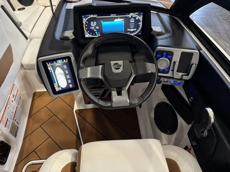 Slide: The Image of 2024 Malibu 23LSV boat dashboard with modern controls and digital displays. - 11