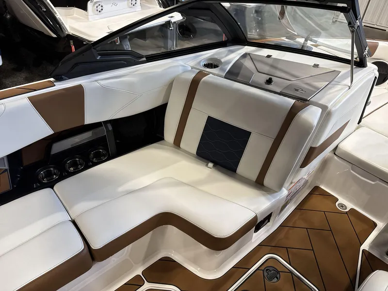 Slide: The Image of 2024 Malibu 23LSV boat interior with white and brown seating, modern design. - 12