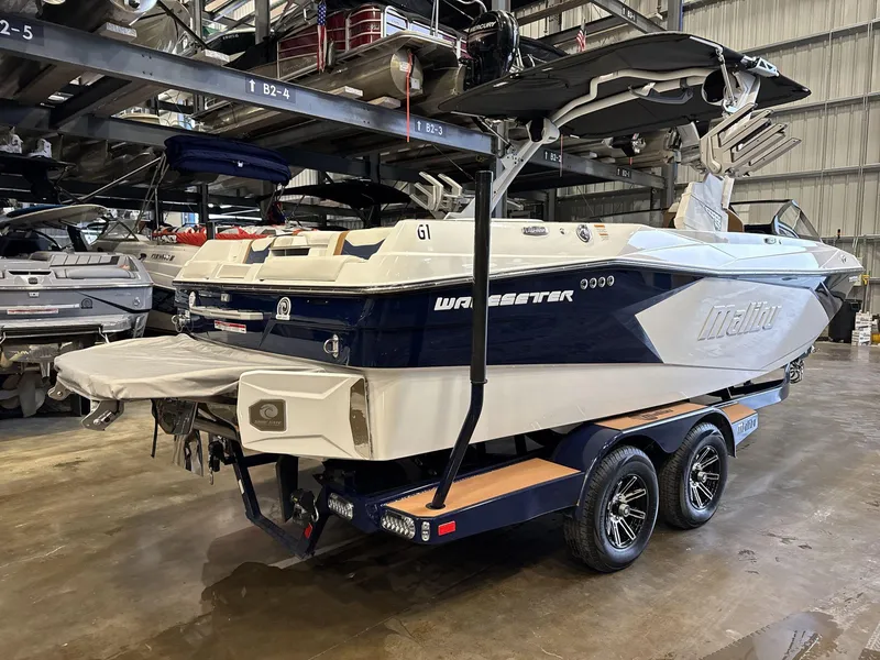 Slide: The Image of 2024 Malibu 23LSV boat on trailer in storage facility. - 6