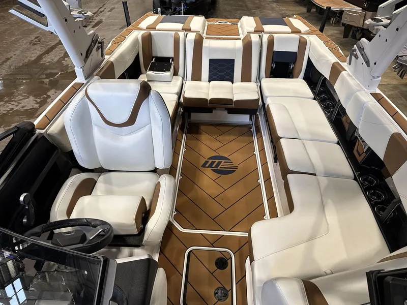Slide: The Image of 2024 Malibu 23LSV boat interior with luxurious white and brown seating. - 9