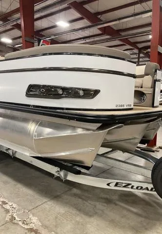 Slide: The Image of 2025 Avalon 23 Catalina Versatile Rear Bench pontoon boat on trailer in warehouse. - 8