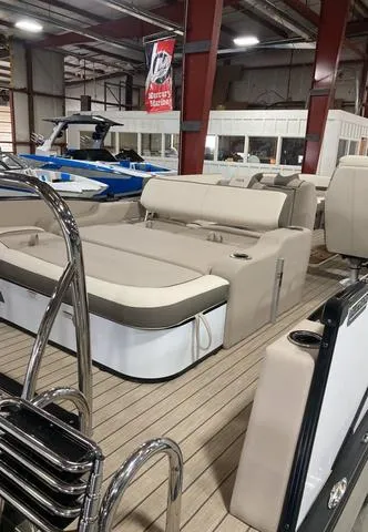 Slide: The Image of 2025 Avalon 23 Catalina Versatile Rear Bench boat in showroom, featuring beige seating. - 9