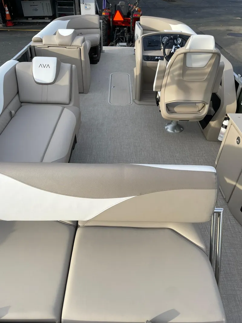 Slide: The Image of 2025 Avalon LSZ Cruise Rear Bench boat interior with beige seating and modern helm. - 23