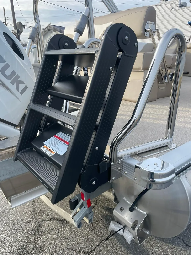 Slide: The Image of 2025 Avalon LSZ Cruise Rear Bench with foldable boat ladder and Suzuki motor. - 5