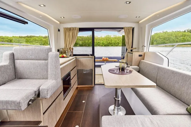 Slide: The Image of Luxurious interior of 2025 Sealine C335V yacht with modern seating and dining area. - 11