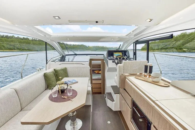 Slide: The Image of Luxurious interior of 2025 Sealine C335V yacht with modern furnishings and scenic water view. - 12