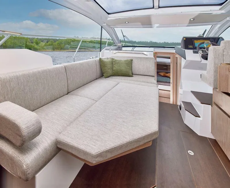 Slide: The Image of 2025 Sealine C335V yacht interior with spacious seating and modern helm. - 14