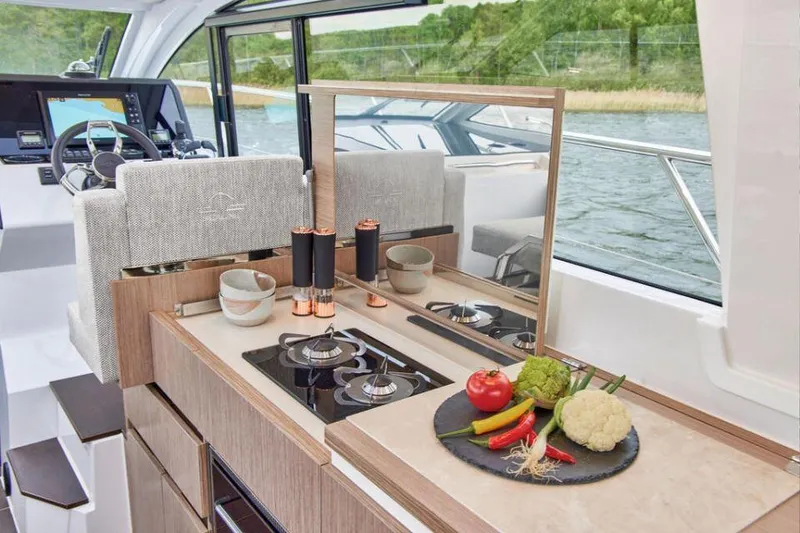 Slide: The Image of Interior of 2025 Sealine C335V yacht with modern kitchen and scenic water view. - 16