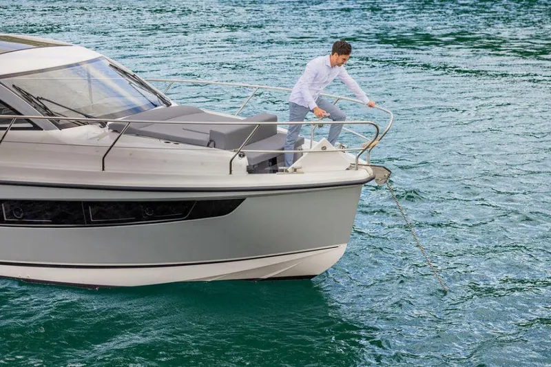 Slide: The Image of 2025 Sealine C335V yacht on water with person handling anchor. - 6