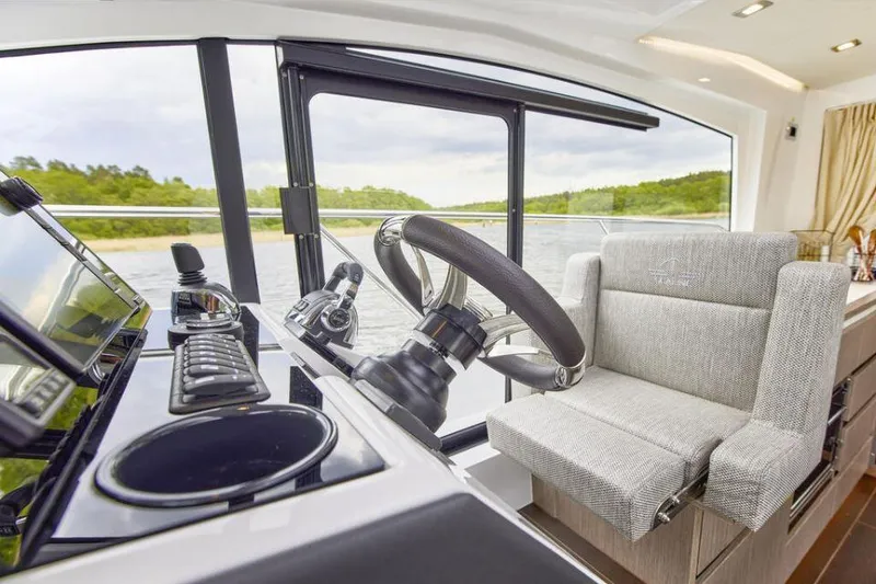 Slide: The Image of 2025 Sealine C335V yacht helm with modern controls and comfortable seating. - 9