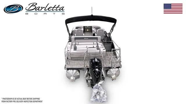 Slide: The Image of 2025 Barletta A22UC pontoon boat, rear view, with motor and seating, USA flag. - 3