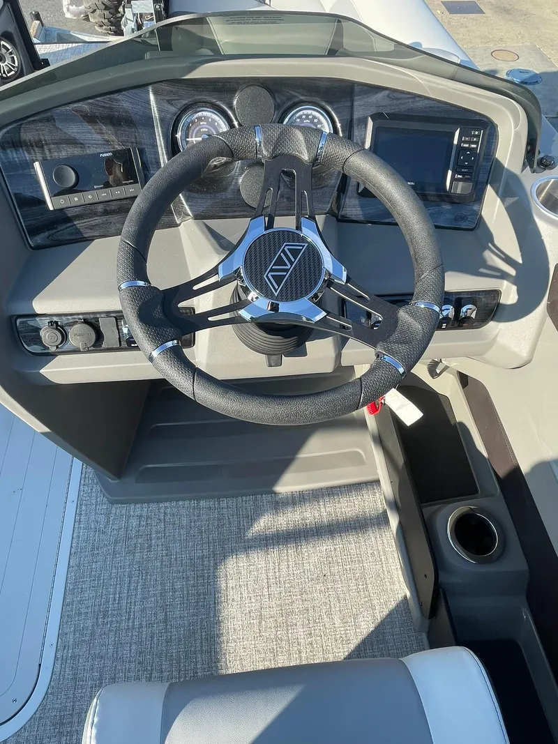 Slide: The Image of 2025 Avalon LSZ ELITE boat dashboard with steering wheel and controls. - 16