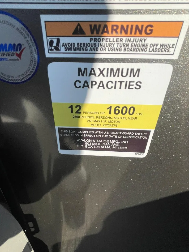 Slide: The Image of Warning label on 2025 Avalon LSZ ELITE boat showing maximum capacities and safety instructions. - 20