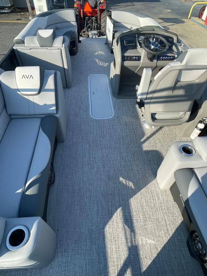 Slide: The Image of 2025 Avalon LSZ ELITE pontoon boat interior with modern seating and steering console. - 22