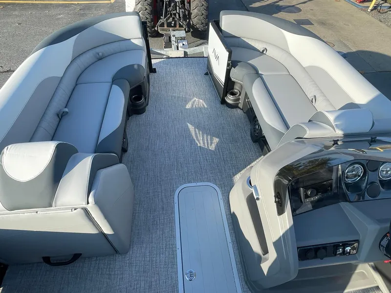 Slide: The Image of 2025 Avalon LSZ ELITE boat interior with gray seating and modern dashboard. - 23