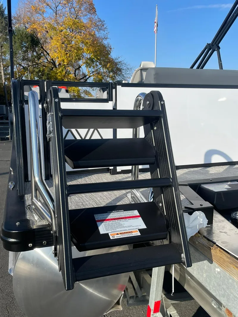 Slide: The Image of 2025 Avalon LSZ ELITE boat ladder with black steps and metal frame. - 4