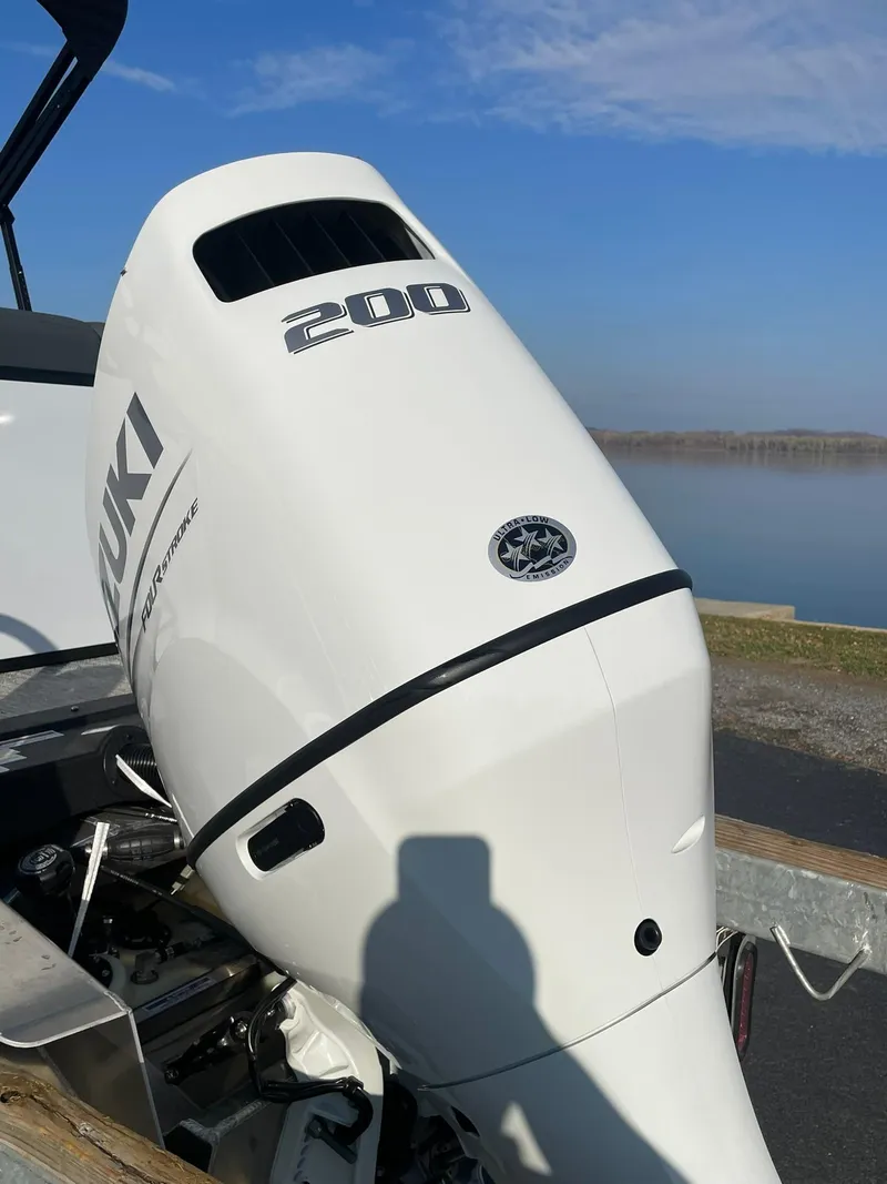 Slide: The Image of 2025 Avalon LSZ ELITE with Suzuki 200 outboard motor by a lake. - 5