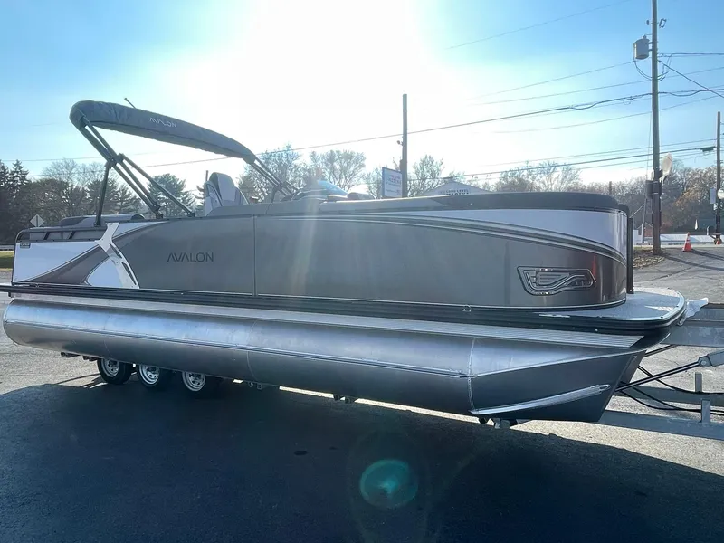 Slide: The Image of 2025 Avalon LSZ ELITE pontoon boat in sunlight, showcasing sleek design and modern features. - 8