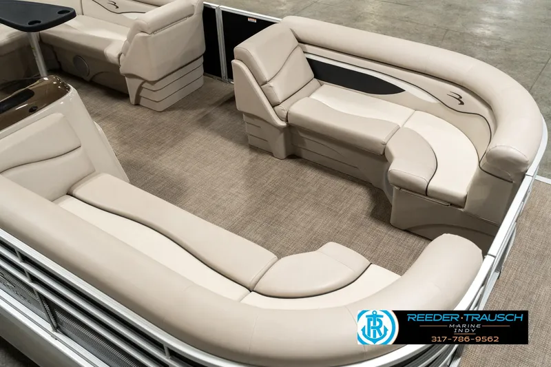 Slide: The Image of 2019 Bennington 21 SLX pontoon boat interior with beige seating and carpet flooring. - 10