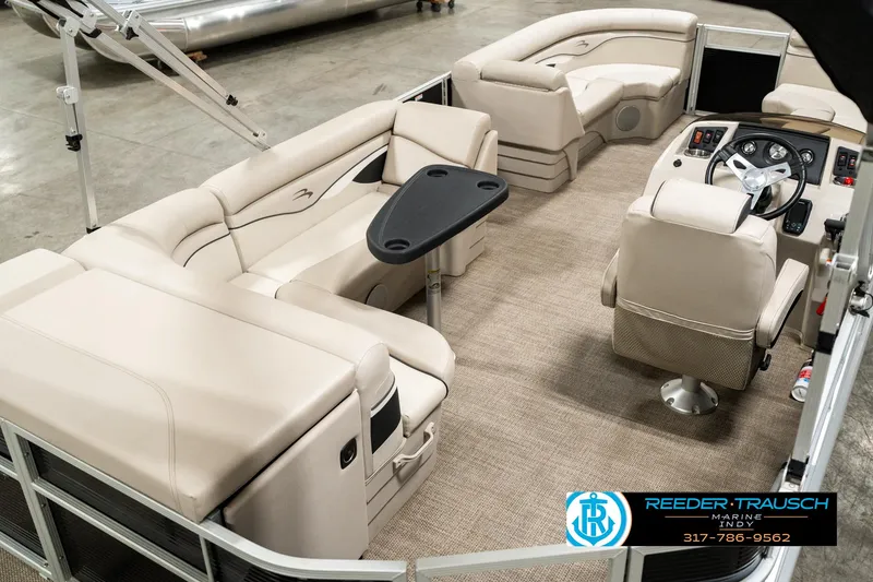 Slide: The Image of 2019 Bennington 21 SLX pontoon boat interior with beige seating and steering console. - 11