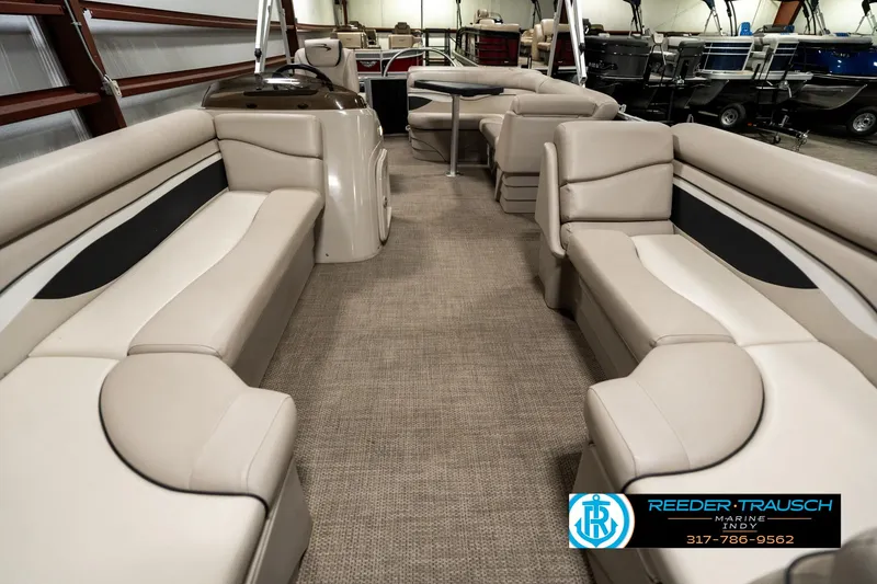 Slide: The Image of 2019 Bennington 21 SLX pontoon boat interior with beige seating and carpet flooring. - 13