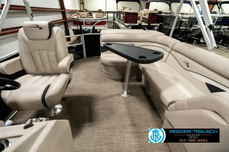 Slide: The Image of 2019 Bennington 21 SLX pontoon boat interior with beige seating and table. - 14
