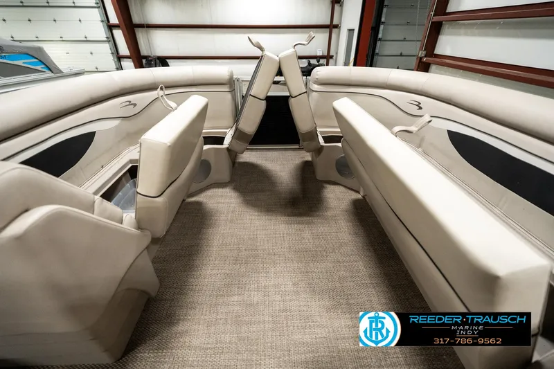 Slide: The Image of 2019 Bennington 21 SLX boat interior with beige seating and carpet flooring. - 19